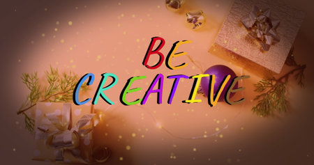 Displaying hand-lettered BE CREATIVE text on tabletop setup, with gift boxes and fairy lights. Festive, holiday, decor, celebration, craft, vibrant, warmの写真素材