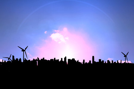 Image of silhouetted cityscape and wind turbines on pink sunset and clouds in blue sky, copy space. Energy, development, nature and communication background concept digitally generated image.の写真素材