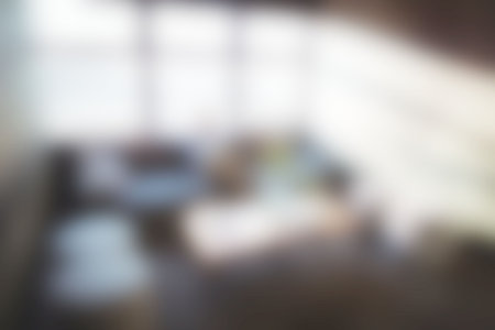 Defocused carefree businessman sitting on sofa in officeの写真素材