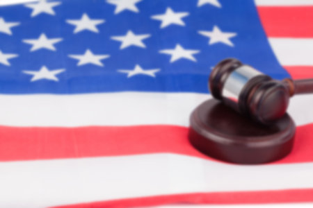 Close-up of gavel on striped American flagの写真素材