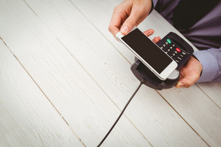 Man using smartphone to express pay