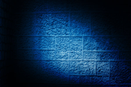 Concrete block wall is being shown in flat design, with blue spotlight beam exposing rough surface....