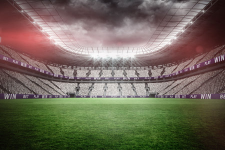 Illuminated soccer stadium against cloudy skyの写真素材