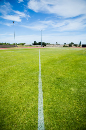 High angle view of yard line on playing field against blue skyの写真素材