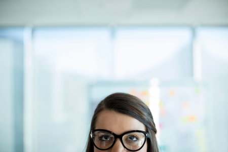 Woman wearing eyeglasses looking upの写真素材