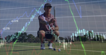 Positioning male golfer crouching on putting green, with putter behind ball and candlestick chart. Athletic, strategic, professional, modern, concentration, outdoor, precisionの写真素材
