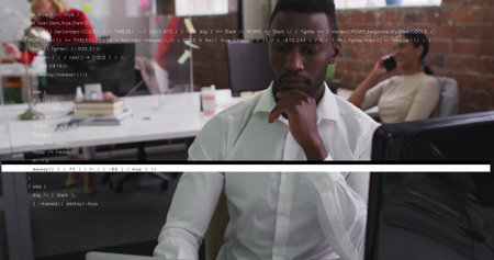Focusing man wearing white shirt coding at open plan office, with coffee mug and smartphone. Corporate, teamwork, productivity, modern, professional, collaboration, technologyの写真素材