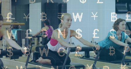 Practicing Pilates on reformers, blonde woman in activewear pulling handles in studio with mirror....
