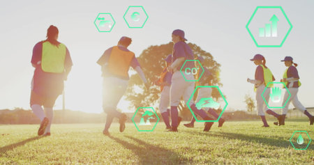 Jogging seven athletes warming up on sports field at sunset, with neon bibs, metric icons. Team, fitness, outdoor, dynamic, vitality, athleticism, innovationの写真素材