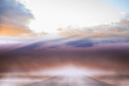 Road leading to clouds against skyの写真素材