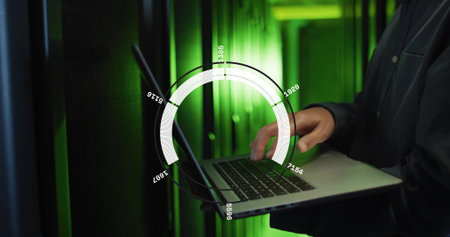 System administrator typing on laptop in data center server room, with network cables, copy space....