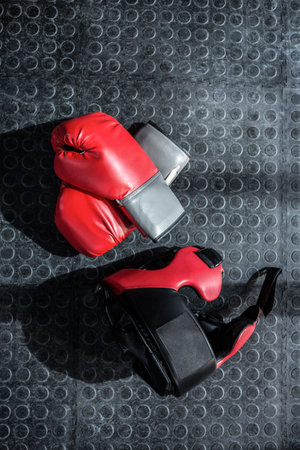High angle view of boxing gloves on floor in gym