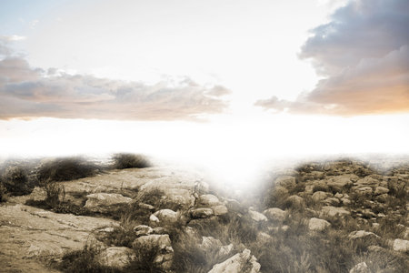 Flat illustration is showcasing arid rocky terrain with slabs, boulders, dry grasses and sun glare. Desert, wilderness, rugged, scenic, natural, minimalist, outdoorの写真素材