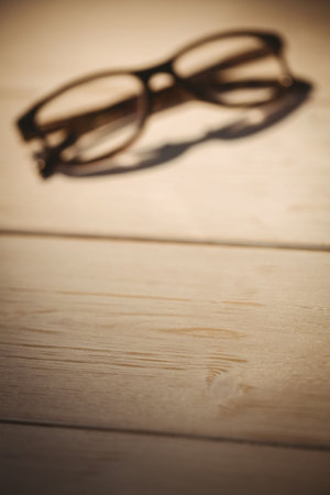 Close-up of black eyeglasses kept on tableの写真素材