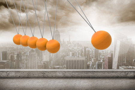 Newtons cradle above cityの写真素材