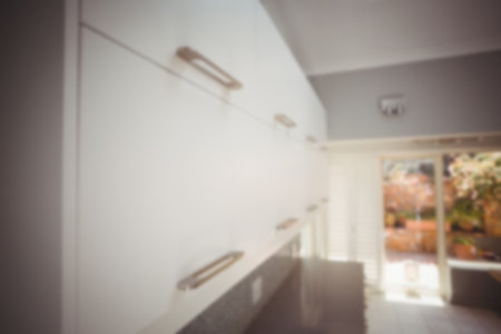 Defocused image of cabinets in kitchen at homeの写真素材
