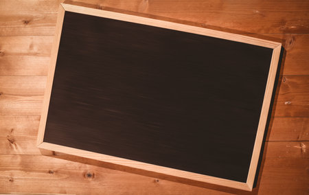 Small blackboard on wooden floor with copy spaceの写真素材