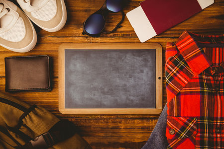 Flat lay illustration is featuring blank chalkboard amid travel essentials: sneakers and passport. Travel gear, adventure, exploration, lifestyle, rustic, casual, accessoriesの写真素材