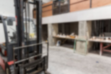 Forklift is parked in flat workshop scene with concrete columns, mezzanine railing, tool benches....