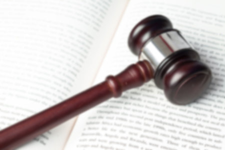 Close-up of wooden gavel on book