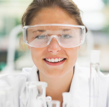 Female scientist smiling at camera in laboratoryの写真素材
