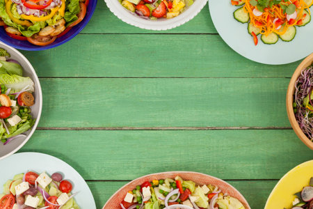 Overhead view of various fresh food on green wooden table