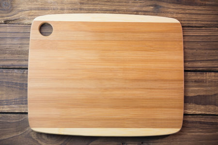 Directly above shot of wooden chopping board on hardwood floorの写真素材