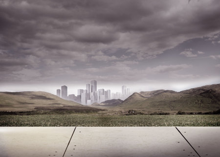 Digitally generated cityscape in distance under cloudy skyの写真素材