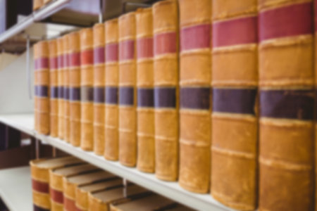 Yellow boks arranged neatly on shelf in library
