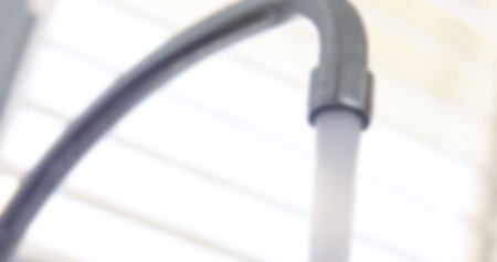 Low angle view of water running from faucetの写真素材