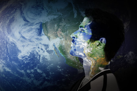 Male profile is displaying flat design jersey with Earth-map face overlay and globe background. Geography, navigation, innovation, futuristic, scientific, exploration, technologyの写真素材