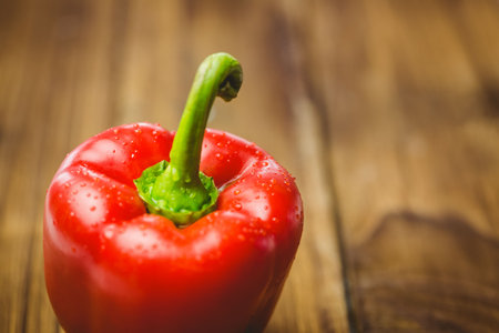 Close-up of fresh red pepper on wooden tableの写真素材