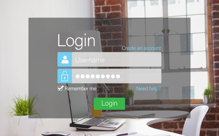 Close-up of login page against laptop on desk in office
