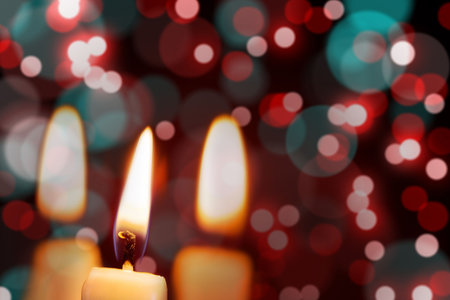 Candle burning against festive background with copy spaceの写真素材