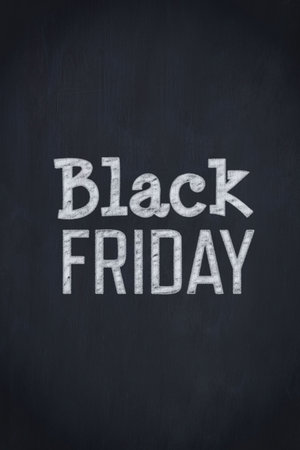 Chalk-style Black Friday lettering is appearing on dark chalkboard with subtle chalk dust. Minimalist, vintage, textured, educational, promotional, bold, handcraftedの写真素材