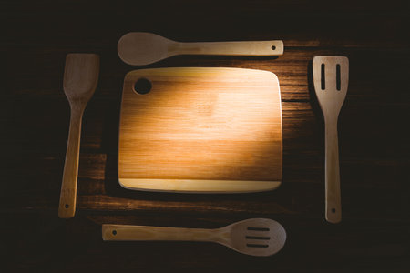 Close-up of chopping board with wooden utensilsの写真素材