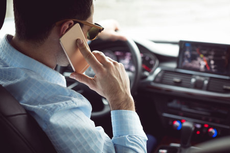 Close-up of man calling while drivingの写真素材