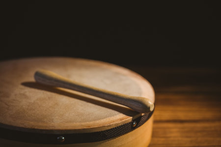 Close-up of wooden stick on bodhran over tableの写真素材