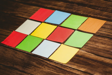 Close-up of colorful papers on wooden surfaceの写真素材