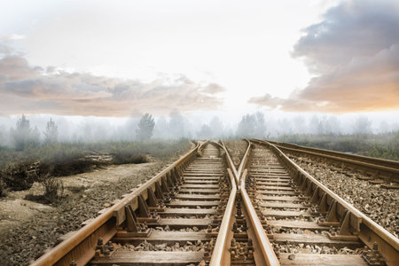 Digitally generated railway tracks leading to misty forestの写真素材
