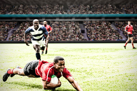 Rugby player jumping with the ball to score touchdown in sports stadiumの写真素材