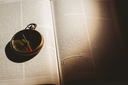 Close-up of pocket watch on open bookの写真素材