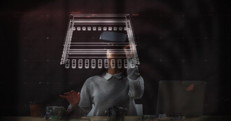 Gesturing female engineer manipulating holographic circuit schematic at lab desk, with AR headset. Futuristic, innovation, technology, engineering, digital, immersive, professionalの写真素材