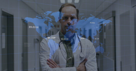 Male doctor wearing white coat, stethoscope crossing arms in hospital corridor, digital map overlay....