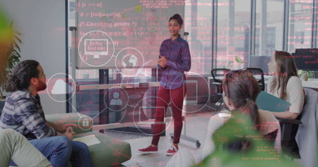 Presenting woman wearing blue top, red pants speaking in office lounge, with flipchart, cloud icons. Collaboration, teamwork, innovation, digital, modern, communication, startupの写真素材