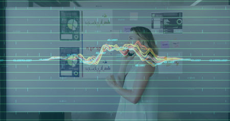 Talking woman in dress reviewing charts on office wall with smartphone, data overlay, copy space....