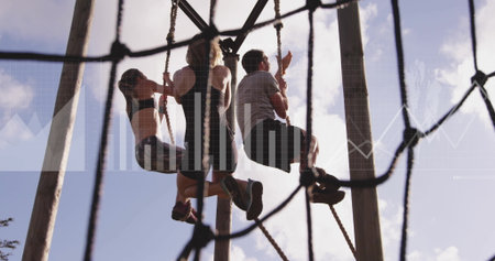 Climbing trio of friends scaling ropes at outdoor ropes course, with rope netting and wooden poles. Adventure, teamwork, outdoor, fitness, obstacle, challenge, athleticの写真素材