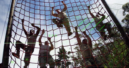 Climbing soldiers in camouflage pants pulling red rope cargo net at forest drill, showing teamwork....