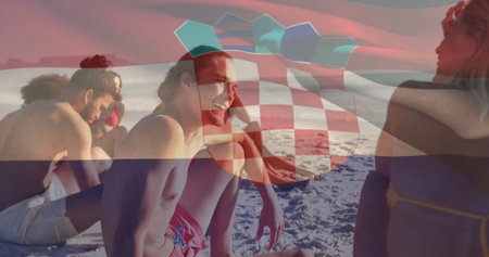 Laughing seven friends wearing swimwear sitting on sandy beach, with turquoise umbrella canopy. Coastline, relaxation, vibrant, leisure, outdoor, companionship, summerの写真素材