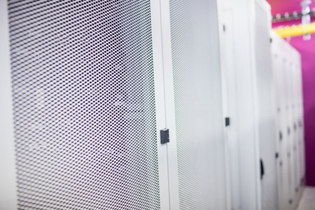 Central server cabinet door is being shown in flat design data center aisle, featuring yellow trays. Technology, infrastructure, networking, digital, industrial, modern, connectivityの写真素材